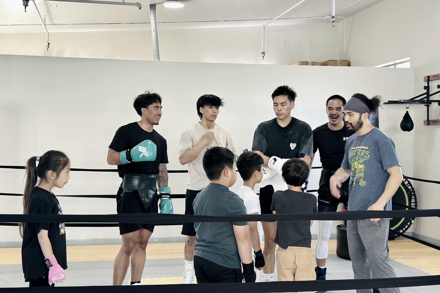 A coach running a class for kids and adults together