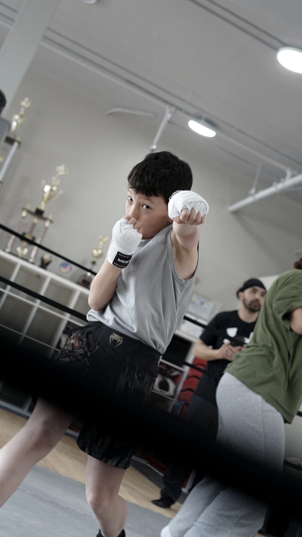 A young boxer with his hands up