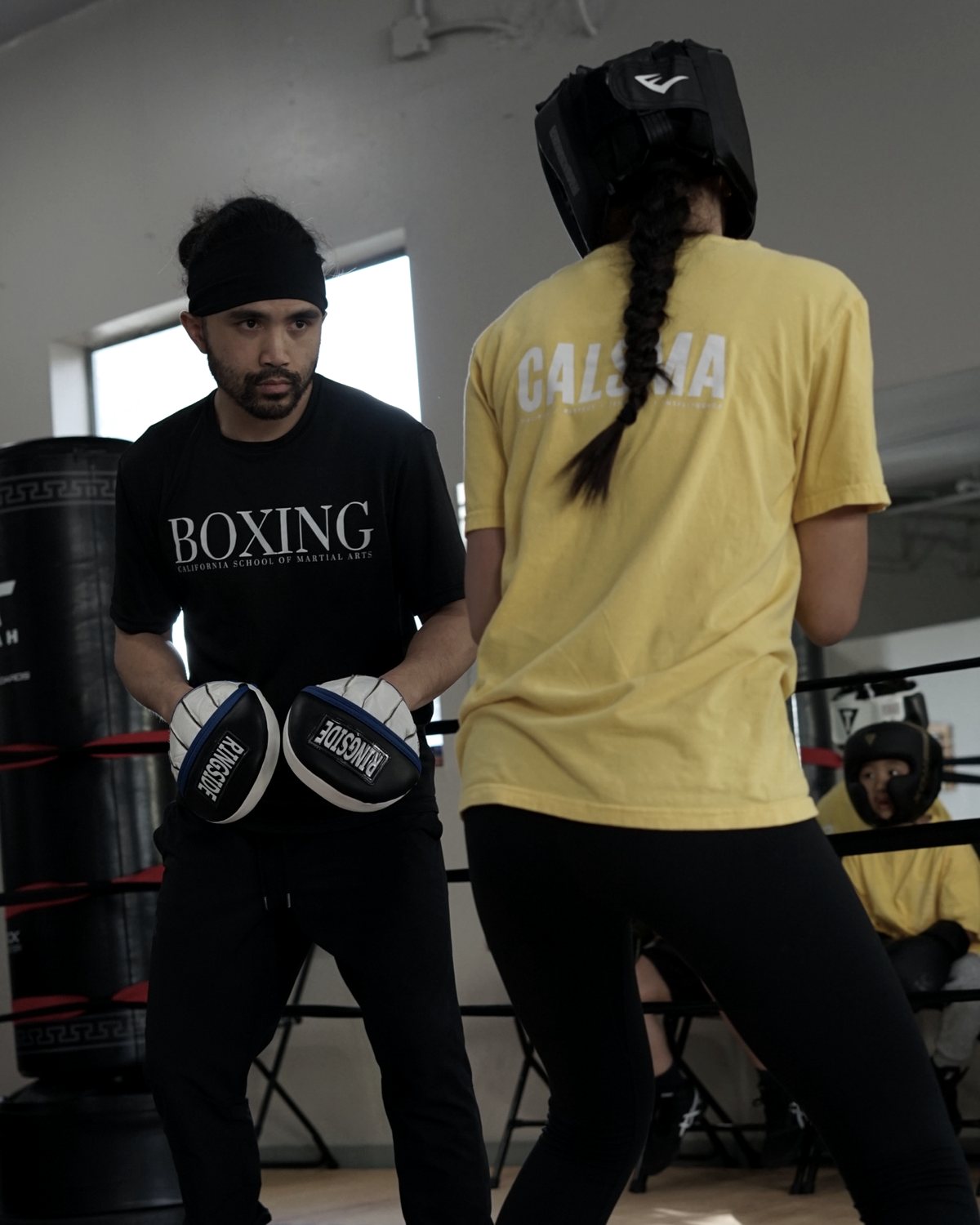 Coach Irwin holding the mitts for a student